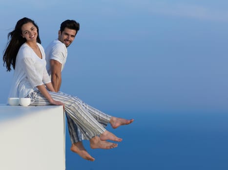 happy young romantic couple have fun relax smile at modern home outdoor terace balcony terace