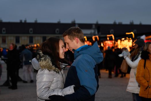 Young couple teasing each other at the Christmas market.