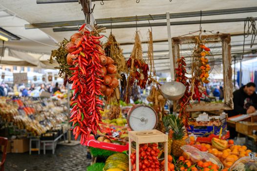 Dried chilli are offered for sale at a weekly Roman market.