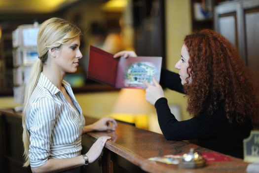 business woman  at the reception of a hotel checking in