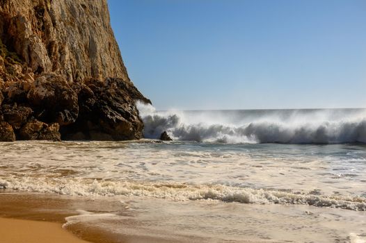 A sandy beach at the Algarve in Portugal with some powerful waves.