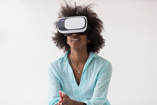 Happy african american girl getting experience using VR headset glasses of virtual reality, isolated on white background