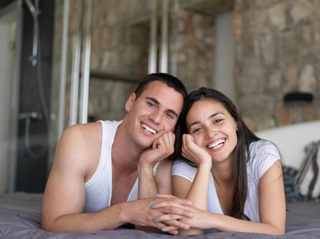 happy young couple relax and have fun in bed