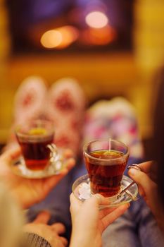 happy Young romantic couple sitting on sofa in front of fireplace at winter season in home