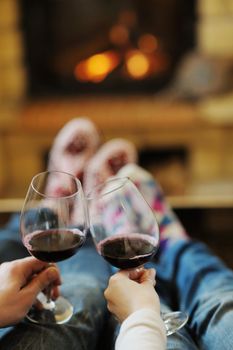 happy Young romantic couple and relaxing sofa in front of fireplace at winter season in home