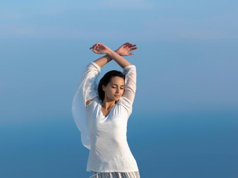 happy young woman enjoy sunset while dancing and enjoy music on headphones