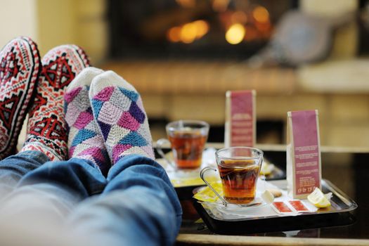 happy Young romantic couple and relaxing sofa in front of fireplace at winter season in home