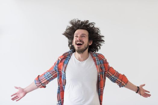 Portrait of an excited casual man standing with open arms and looking at camera isolated on a white background