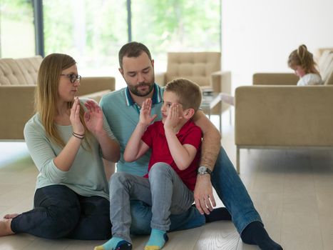 happy young family with little boy enjoys in the modern living room of their luxury home villa