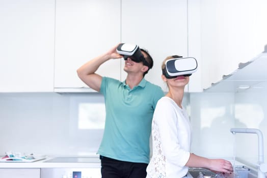happy young couple getting experience using VR-headset glasses of virtual reality at home