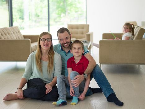 happy young family with little boy enjoys in the modern living room of their luxury home villa