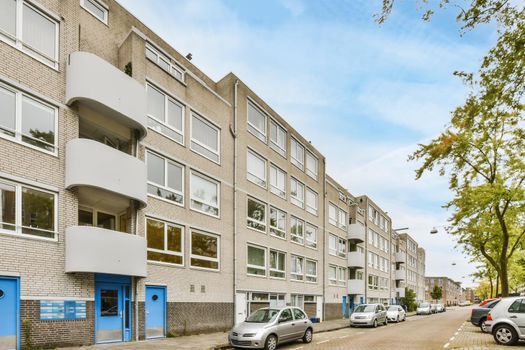 Beautiful view of a residential building with parking