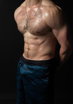 Man on black background keeps dumbbells pumped up in fitness muscle chest torso, arm muscular strong bodybuilder hand, healthy sportive adult, one fit beautiful press with hair