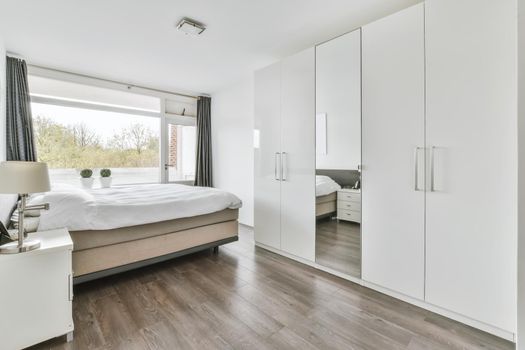Spacious bedroom with a soft double bed and wardrobe