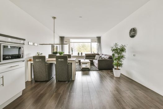 Large modern studio room with living room, dining area and kitchen