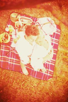 Couple in love enjoying picnic time drink and food in beautiful nature on the river bank top view