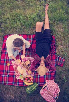 Couple in love enjoying picnic time drink and food in beautiful nature on the river bank top view