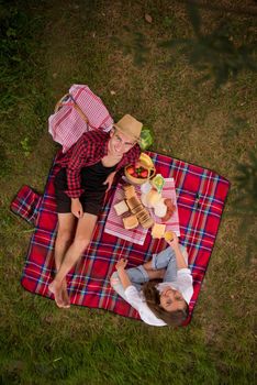 Couple in love enjoying picnic time drink and food in beautiful nature on the river bank top view