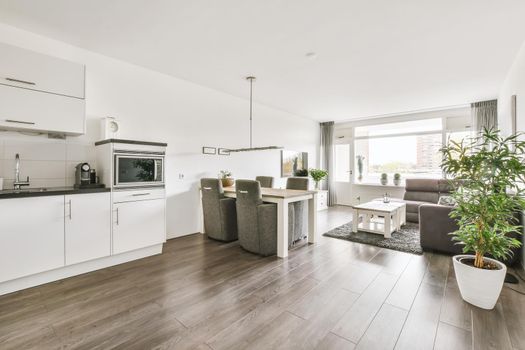 Large modern studio room with living room, dining area and kitchen