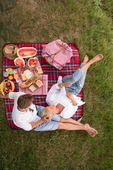 Couple in love enjoying picnic time drink and food in beautiful nature on the river bank top view