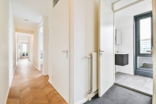 Interior of contemporary flat in minimal style with spacious hallway with white walls