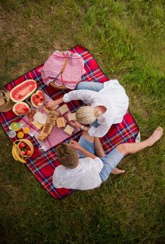 Couple in love enjoying picnic time drink and food in beautiful nature on the river bank top view