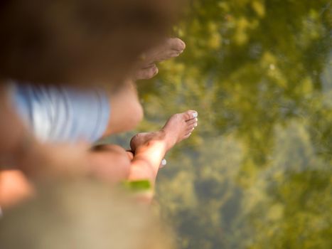 Couple in love enjoying picnic time eating watermelon in beautiful nature on the river bank