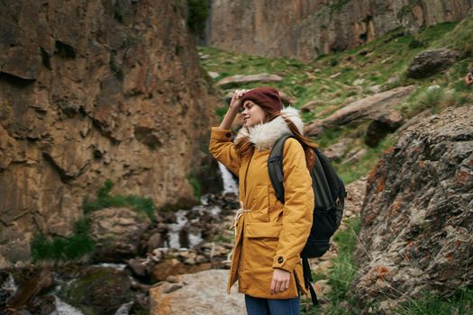 woman hiker with backpack mountains travel adventure freedom. High quality photo