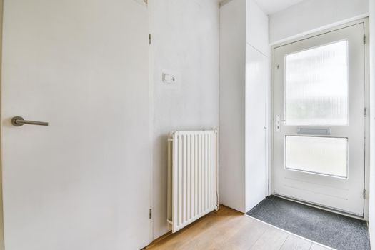 Apartment entrance door with radiator and parquet floor