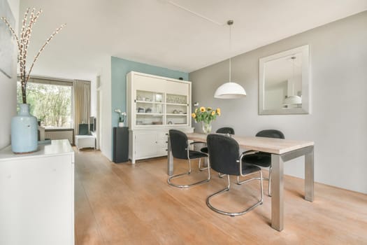 Dining area with stylish table and comfortable soft black chairs