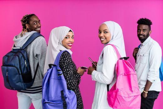 african students group using smart phones with plastic pink background