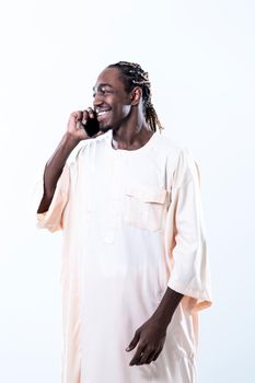 african man using smartphone and wearing traditioinal sudan clothes isolated on white background