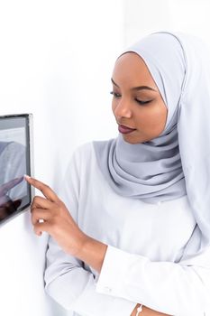 young african modern muslim woman using smart home screen control system