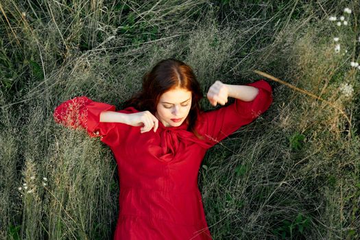 woman in red dress nature green grass landscape rest. High quality photo