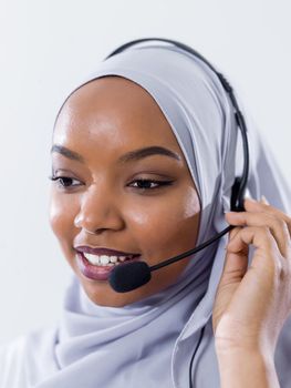 African muslim female with hijab scarf customer representative business woman with phone headset helping and supporting online with customer in modern bright call centre isolated on white background