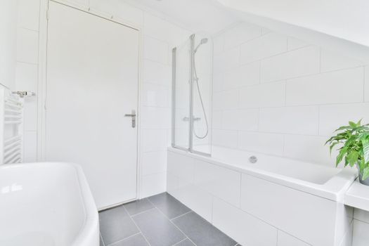 Luxurious bathroom with a huge bathtub in elegant apartment