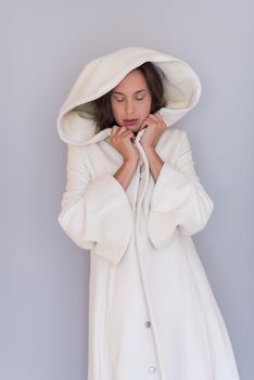 portrait of Beautiful young woman wearing a white coat with hood isolated on white background