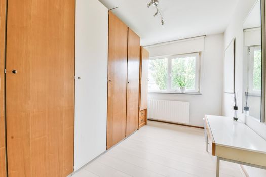 Long room with a full-length wooden wardrobe