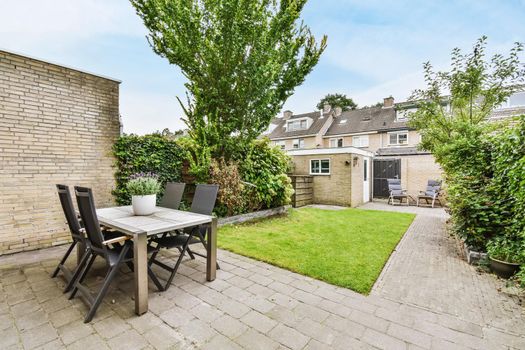 House courtyard with a chic table and comfortable chairs