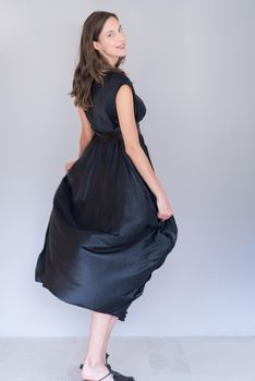 portrait of Beautiful young woman wearing a black dress isolated on white background