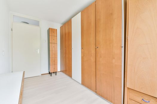 Long room with a full-length wooden wardrobe