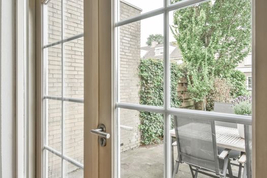 Wooden white closed door overlooking the backyard