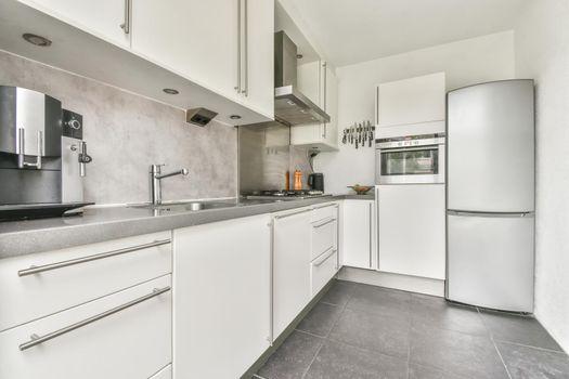 Beautifully laid gray tiled floors in a stylish kitchen