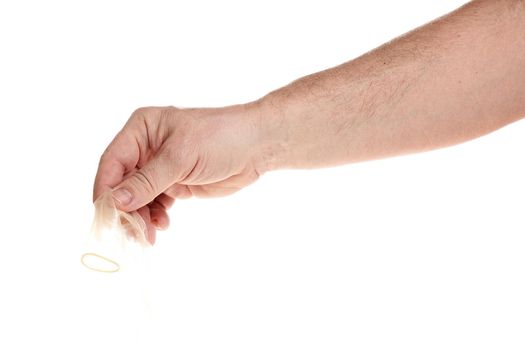 Hand holds a condom on a white background, a template for designers. Close up