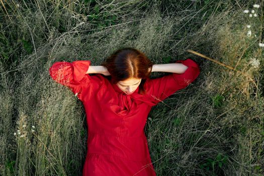 woman in red dress nature green grass landscape rest. High quality photo