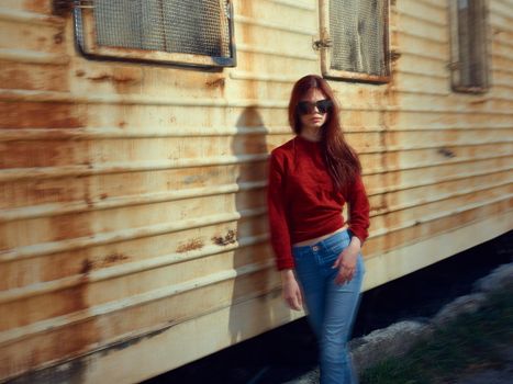 woman on near rusty trailer in the street posing. High quality photo