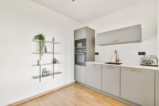 Stunning kitchen with gray kitchen unit and wall shelves