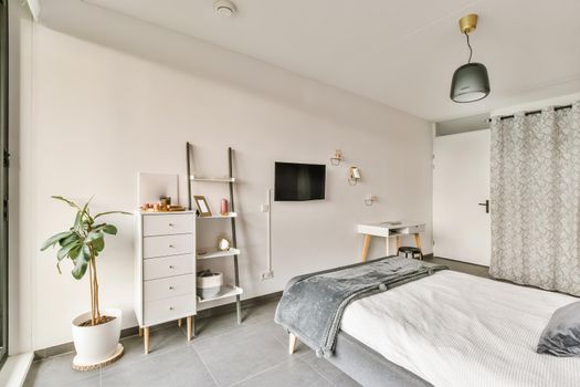 Stunning bedroom with TV opposite the bed and unusual chandelier