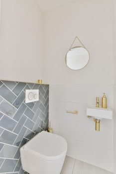 Stunning washroom with blue tiles and small round mirror