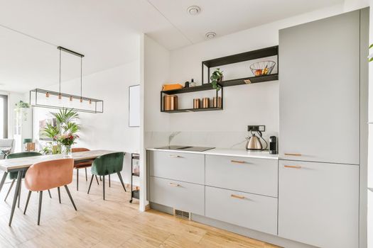 Stunning kitchen with gray kitchen unit and wall shelves